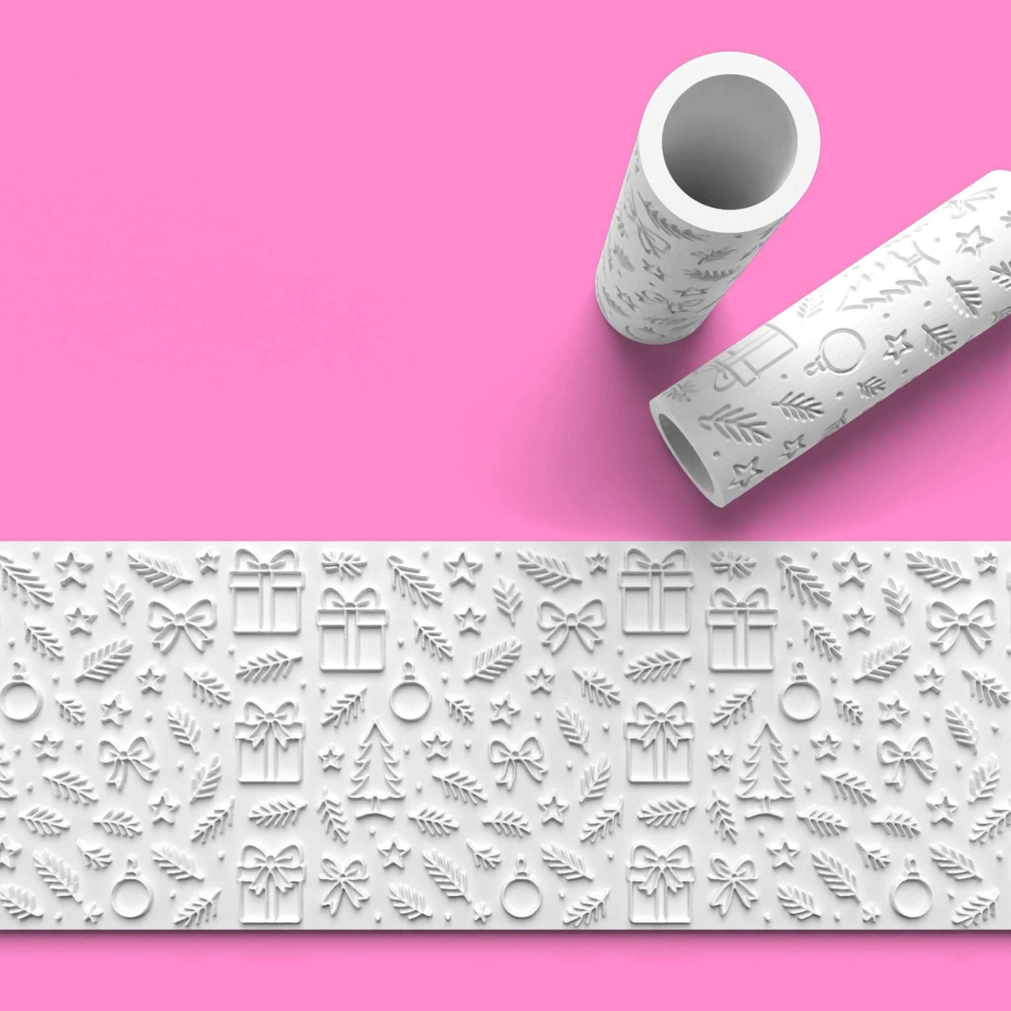 Decorative embossing rolling pin and mat on a pink background