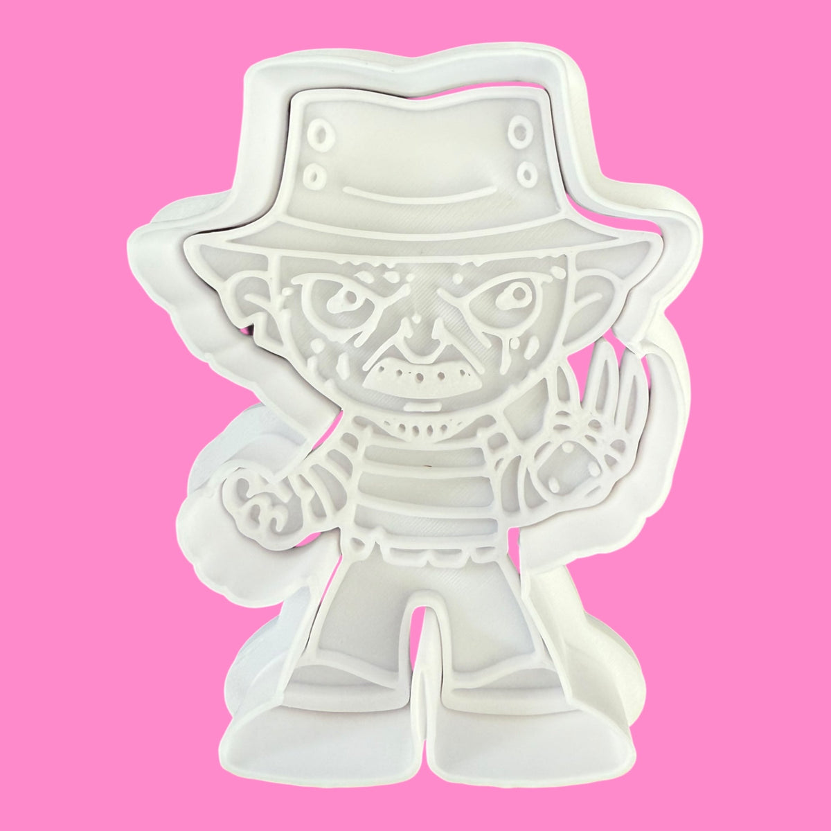 White plastic toy figure on a pink background