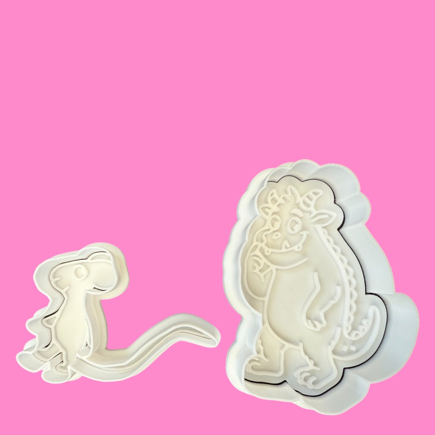 Two cookie cutters in the shapes of the Gruffalo and a mouse, designed for storybook-themed baking.