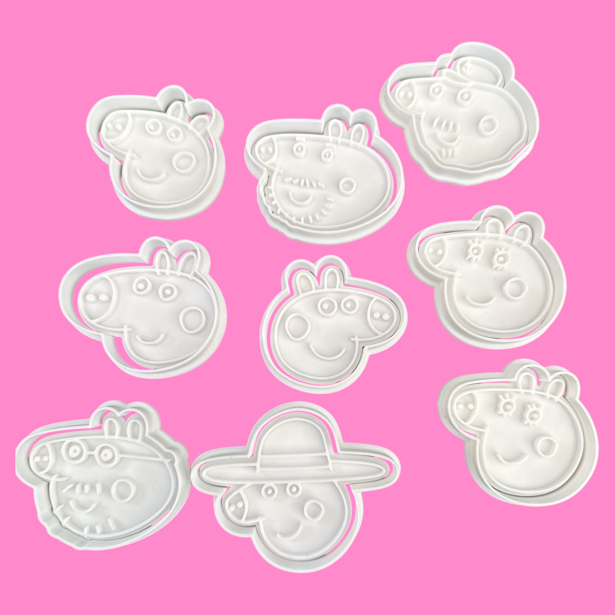 Set of Peppa Pig-themed cookie cutters on a pink background