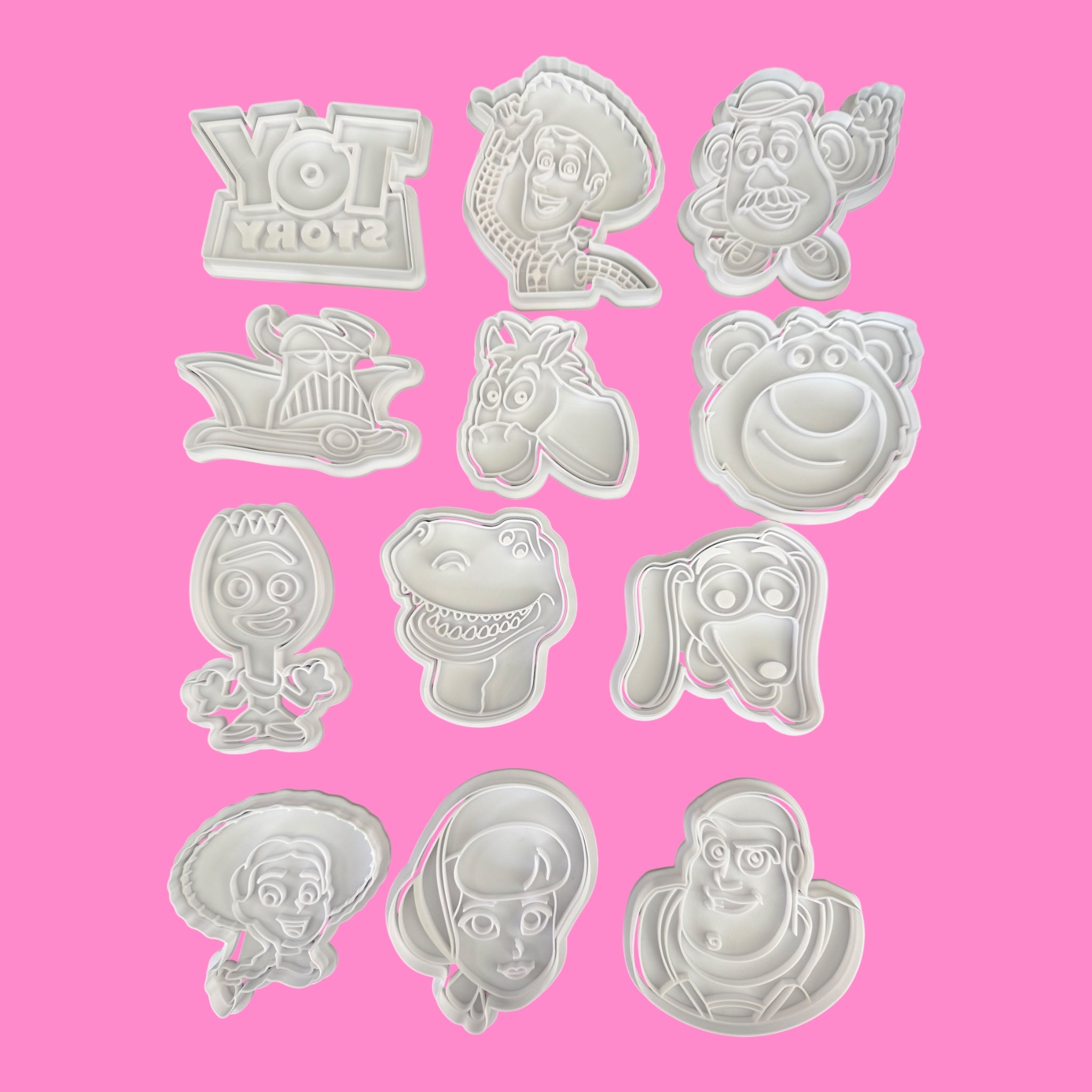 Set of Toy Story-themed cookie cutters on a pink background