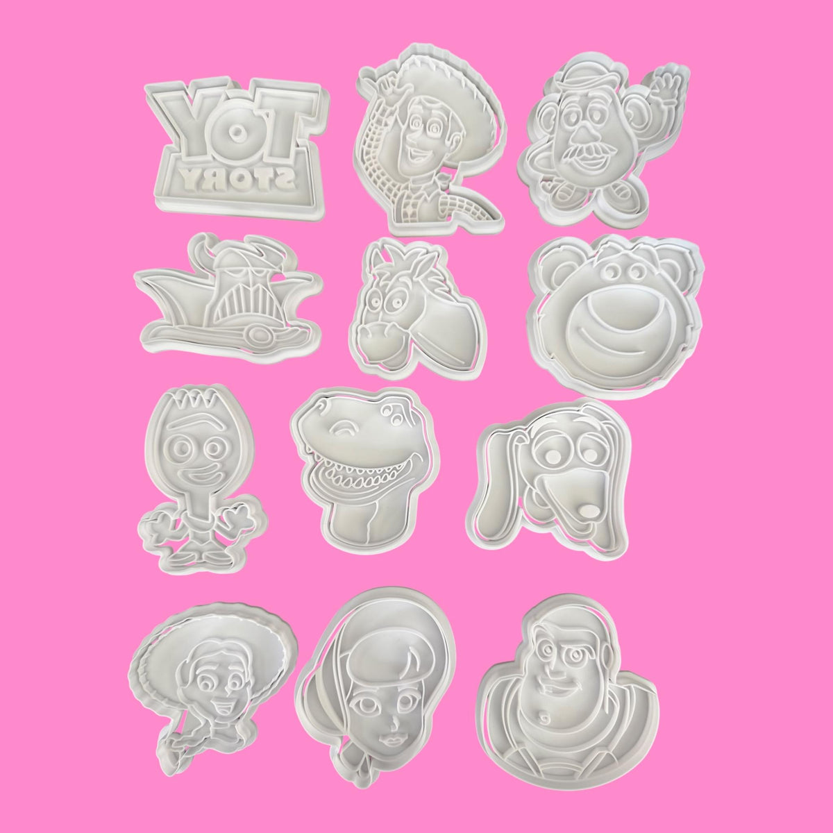 Set of Toy Story-themed cookie cutters on a pink background