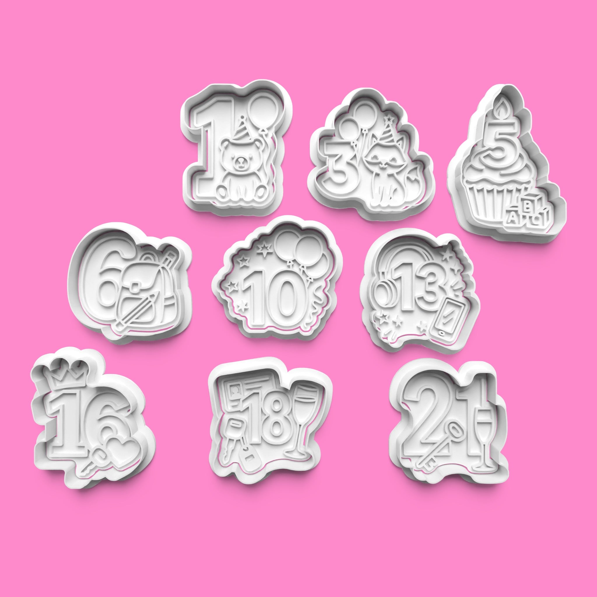 Set of number-themed cookie cutters on a pink background