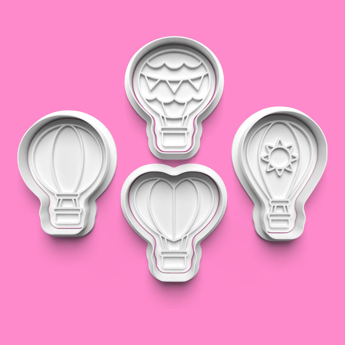 Set of four hot air balloon cookie cutters and embossers featuring classic balloon, bunting balloon, sunshine balloon and heart-shaped balloon designs by Emboss & Impress.