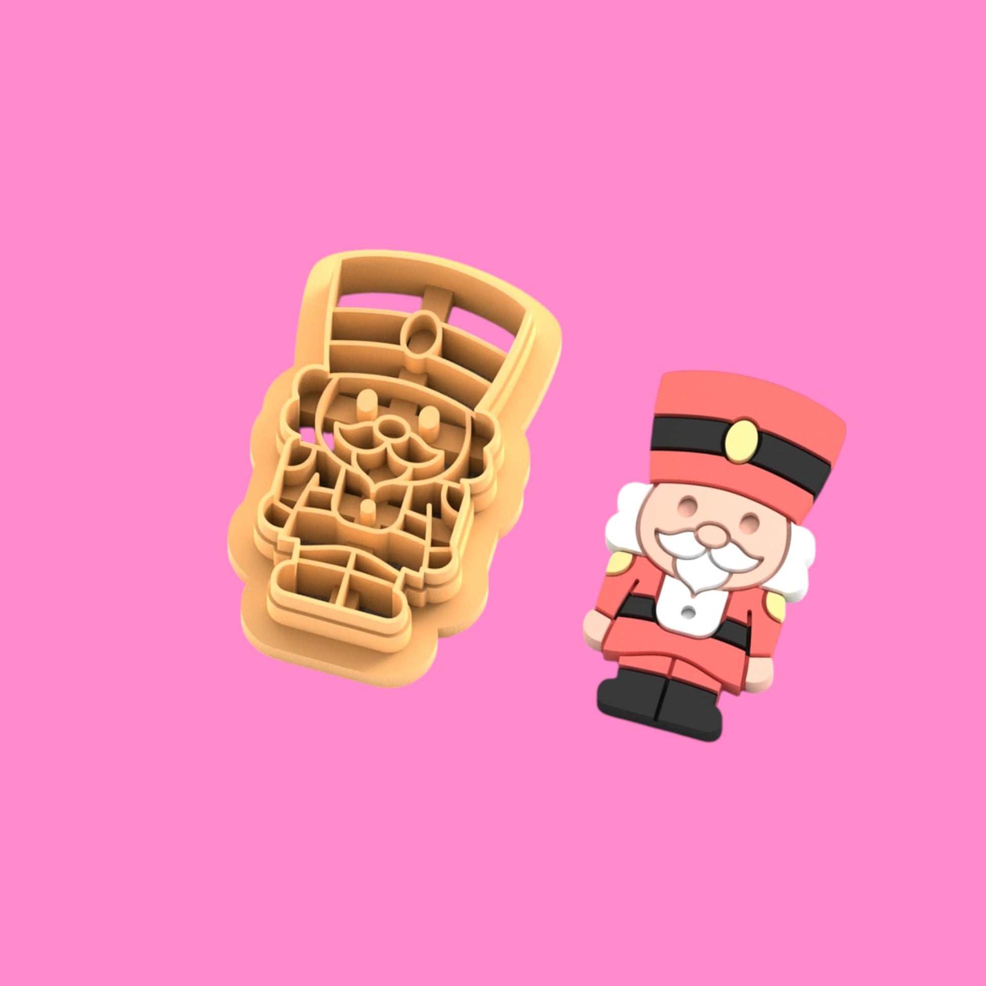 Cookie cutter with Christmas-themed design on a pink background