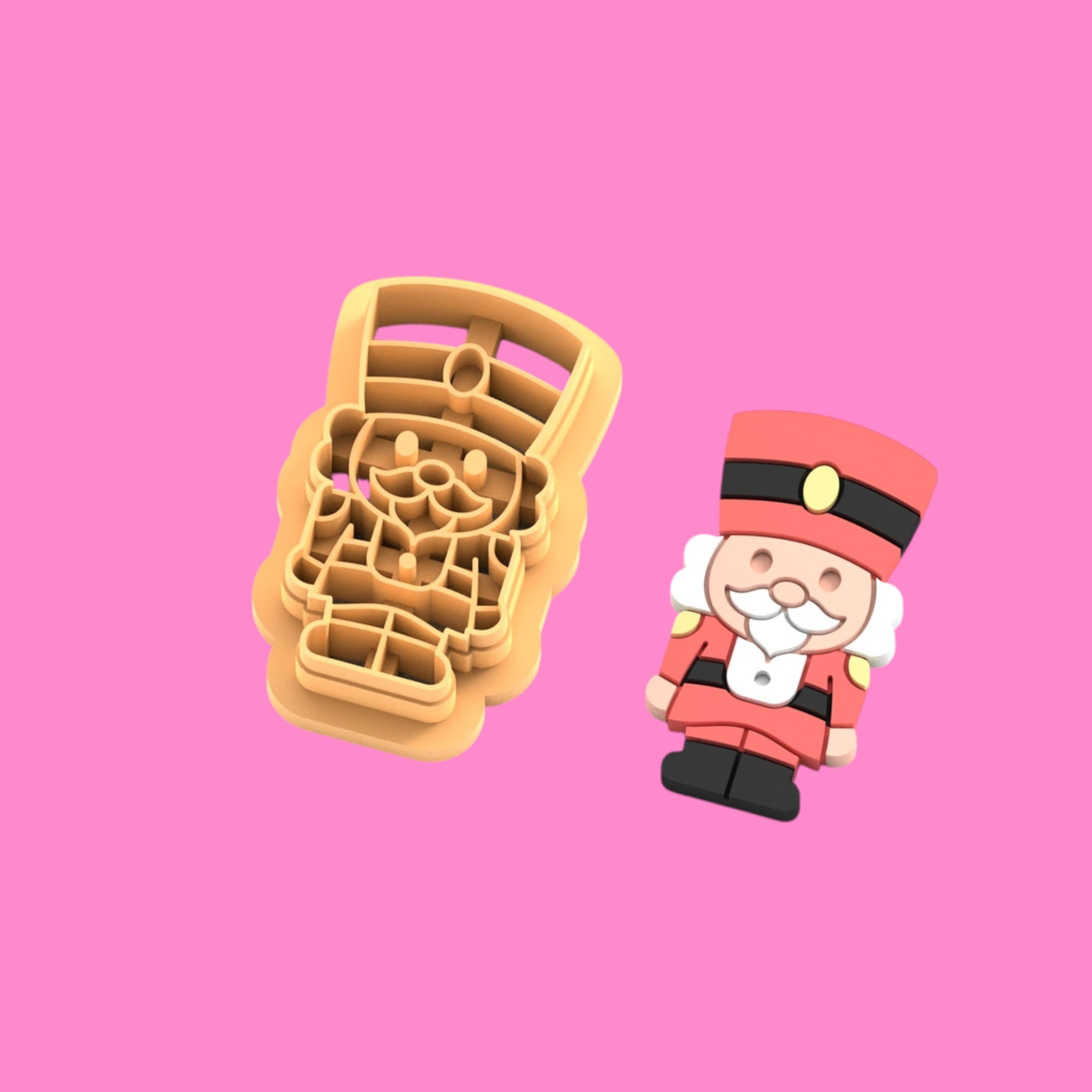 Cookie cutter with Christmas-themed design on a pink background