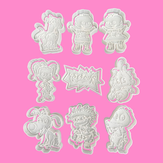 Set of cartoon character cookie cutters on a pink background