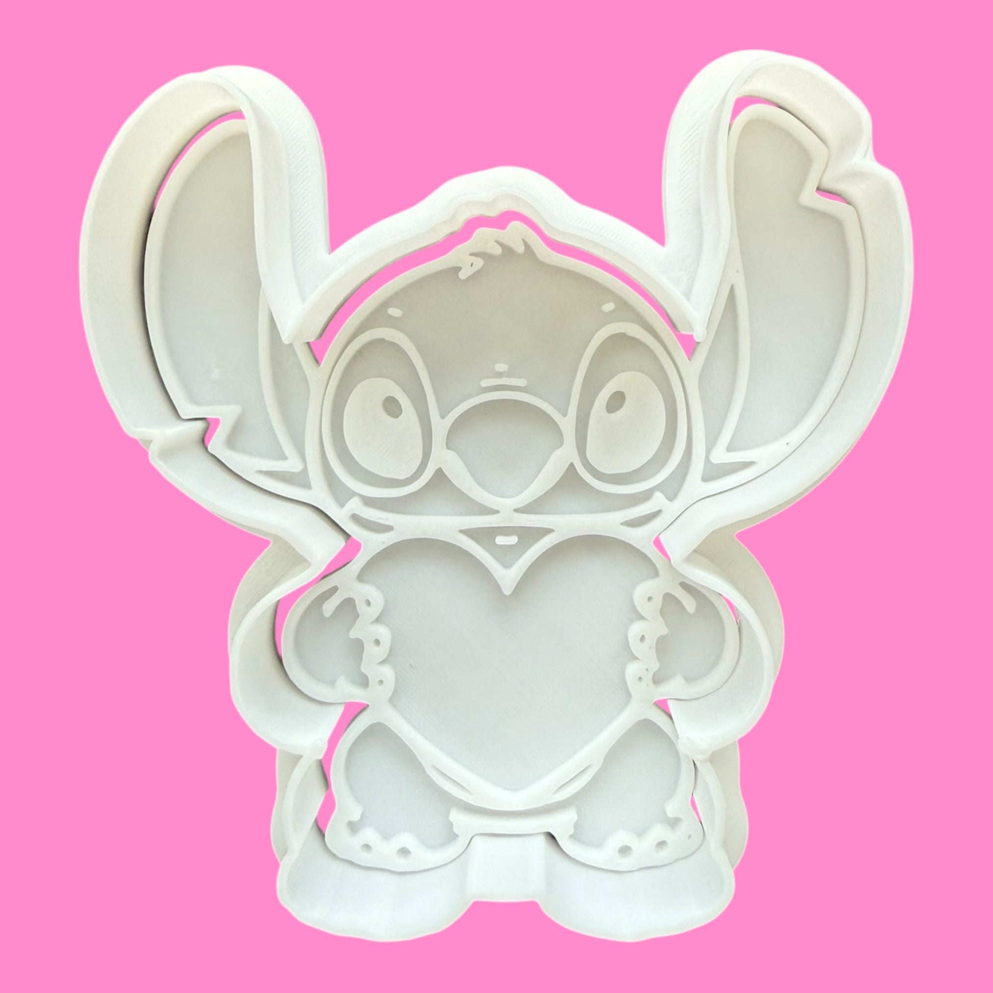 Stitch-shaped cookie cutter on a pink background