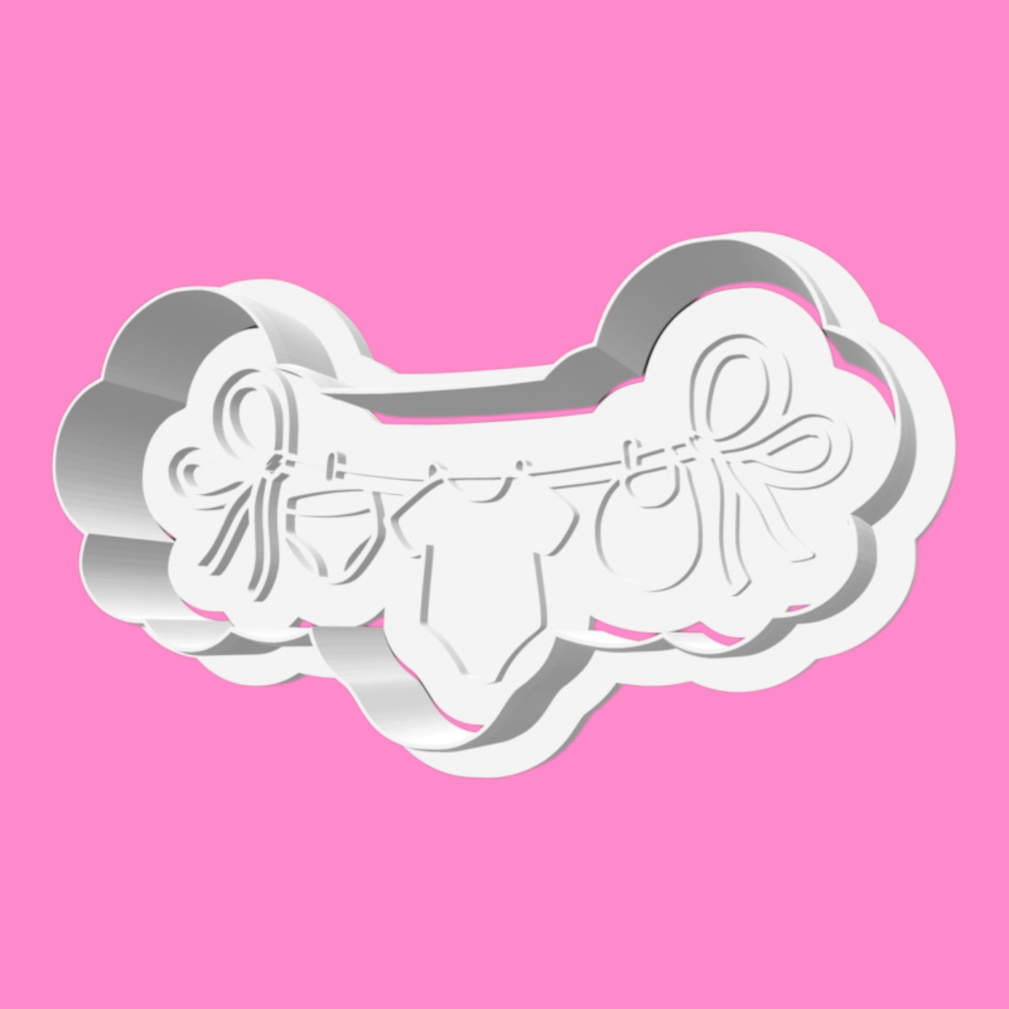 Metallic butterfly-shaped cookie cutter on a pink background