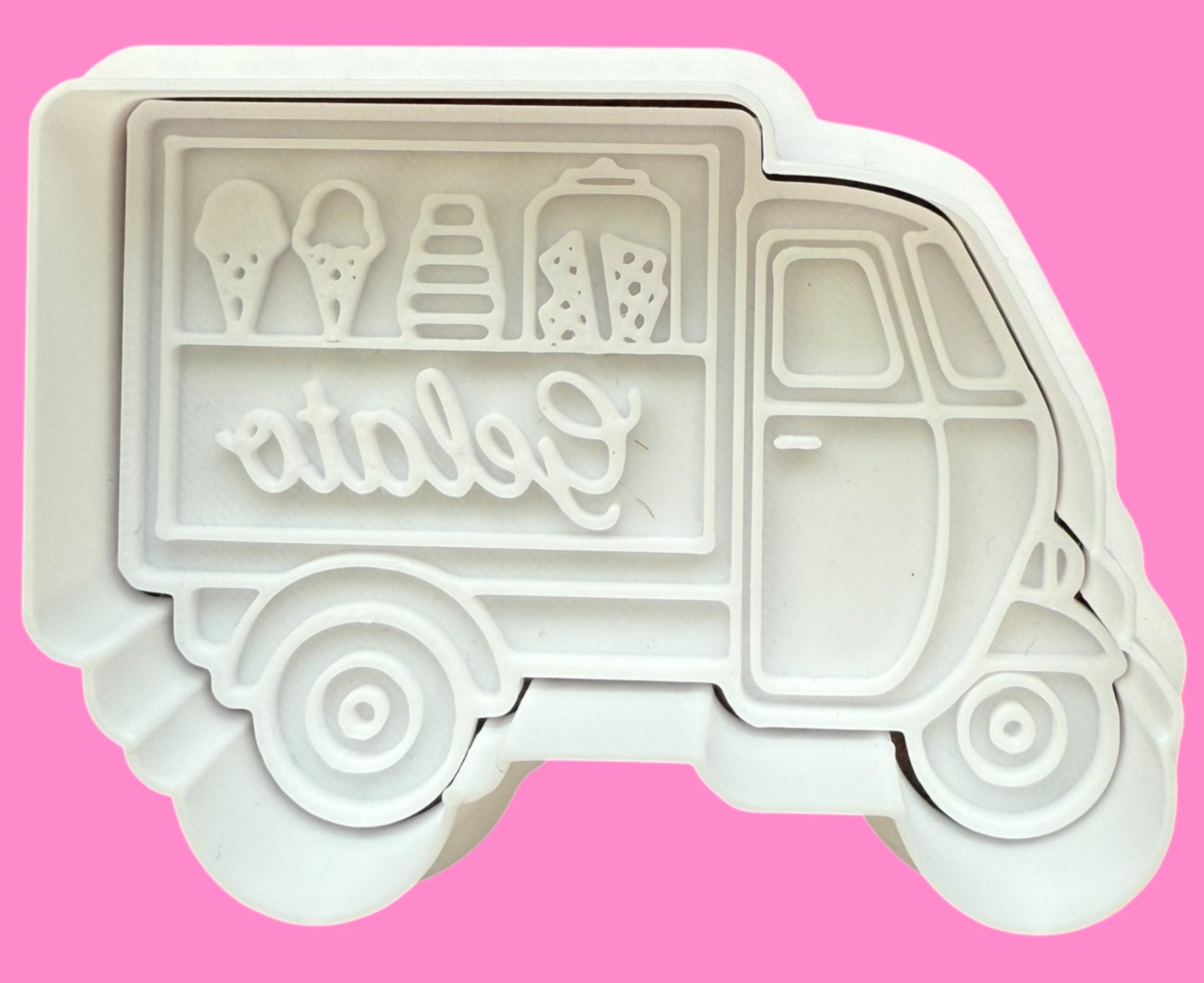 Ice cream truck-shaped cookie cutter with 'atala' branding on a pink background