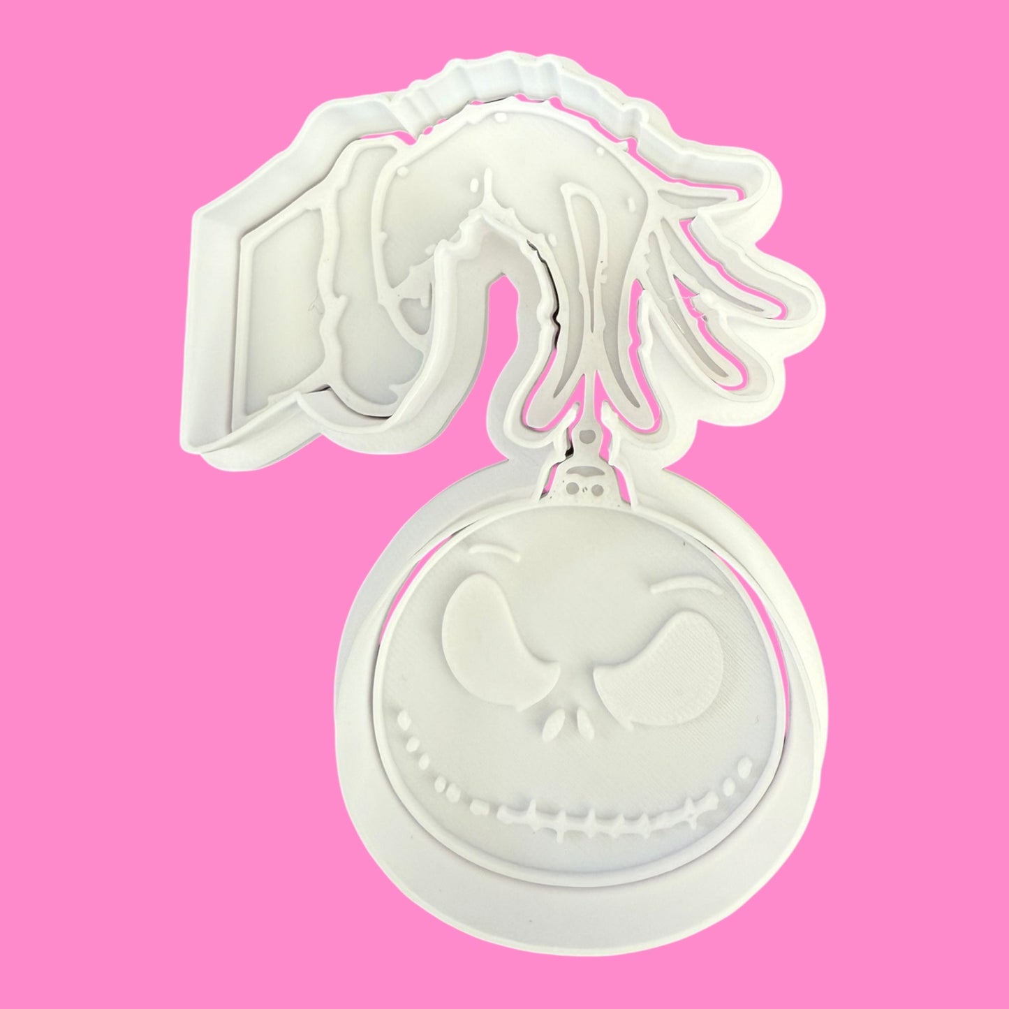 White cookie cutter with a horse design on a pink background