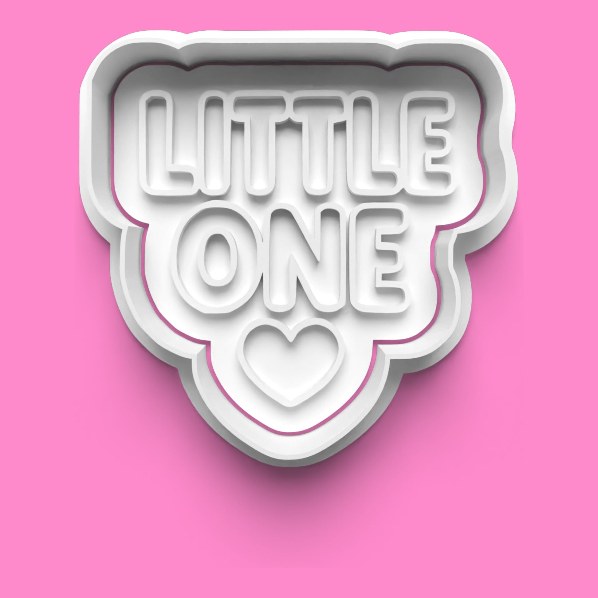Cookie cutter with 'LITTLE ONE' text on a pink background