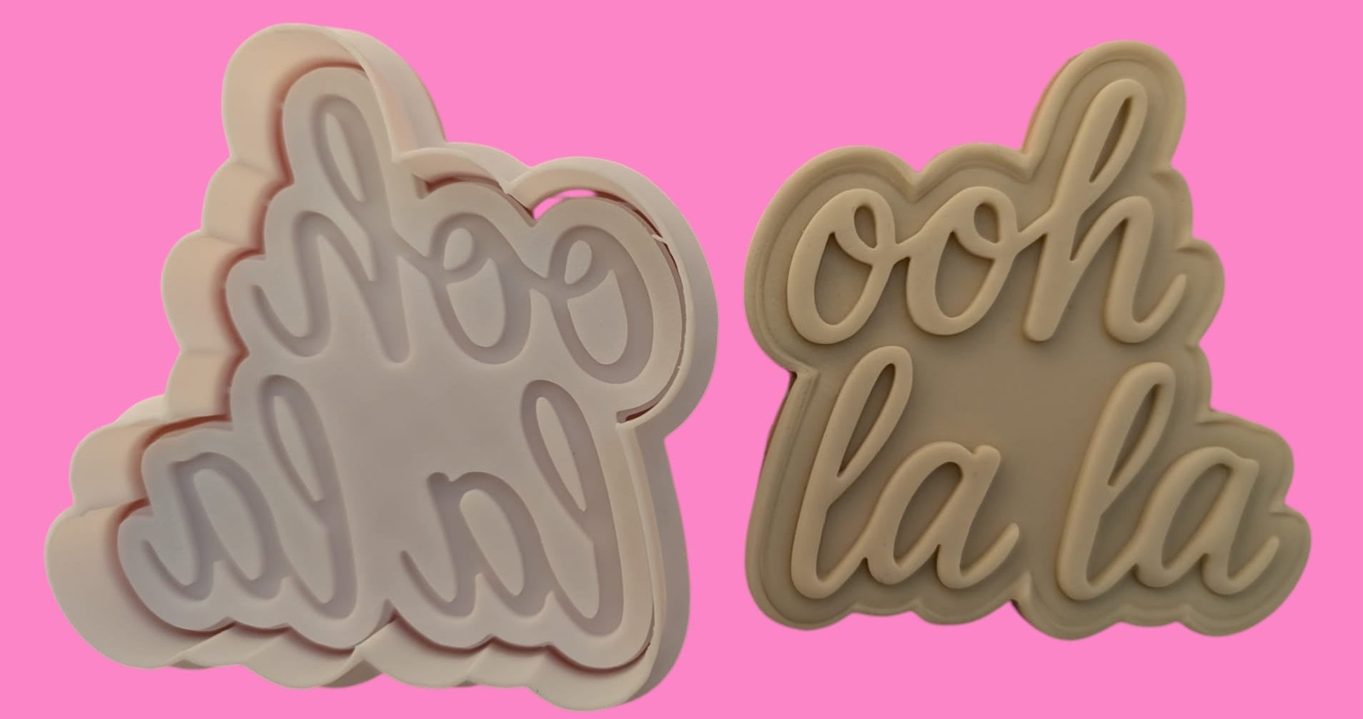 Two cookie cutters with the phrase 'Ooh La La' in a flirty French-inspired design, one for cutting out the letters and the other for the decorative flourishes.