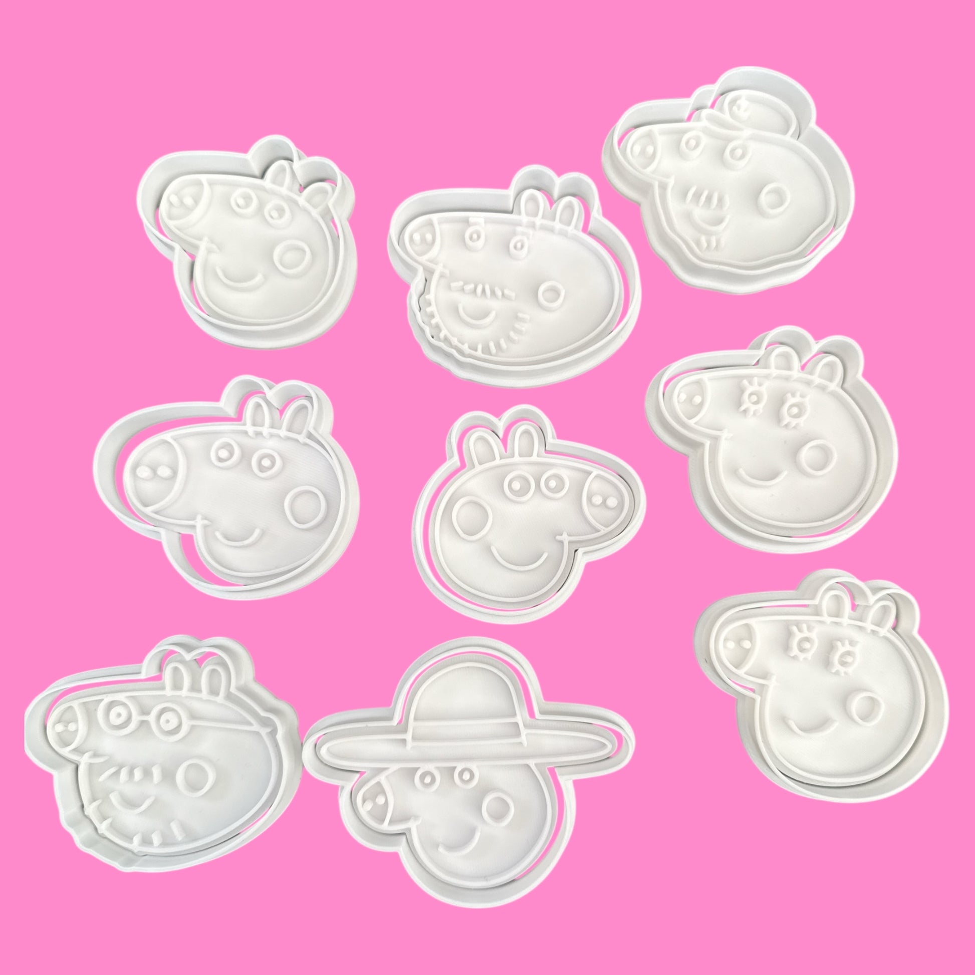 Set of Peppa Pig-themed cookie cutters on a pink background
