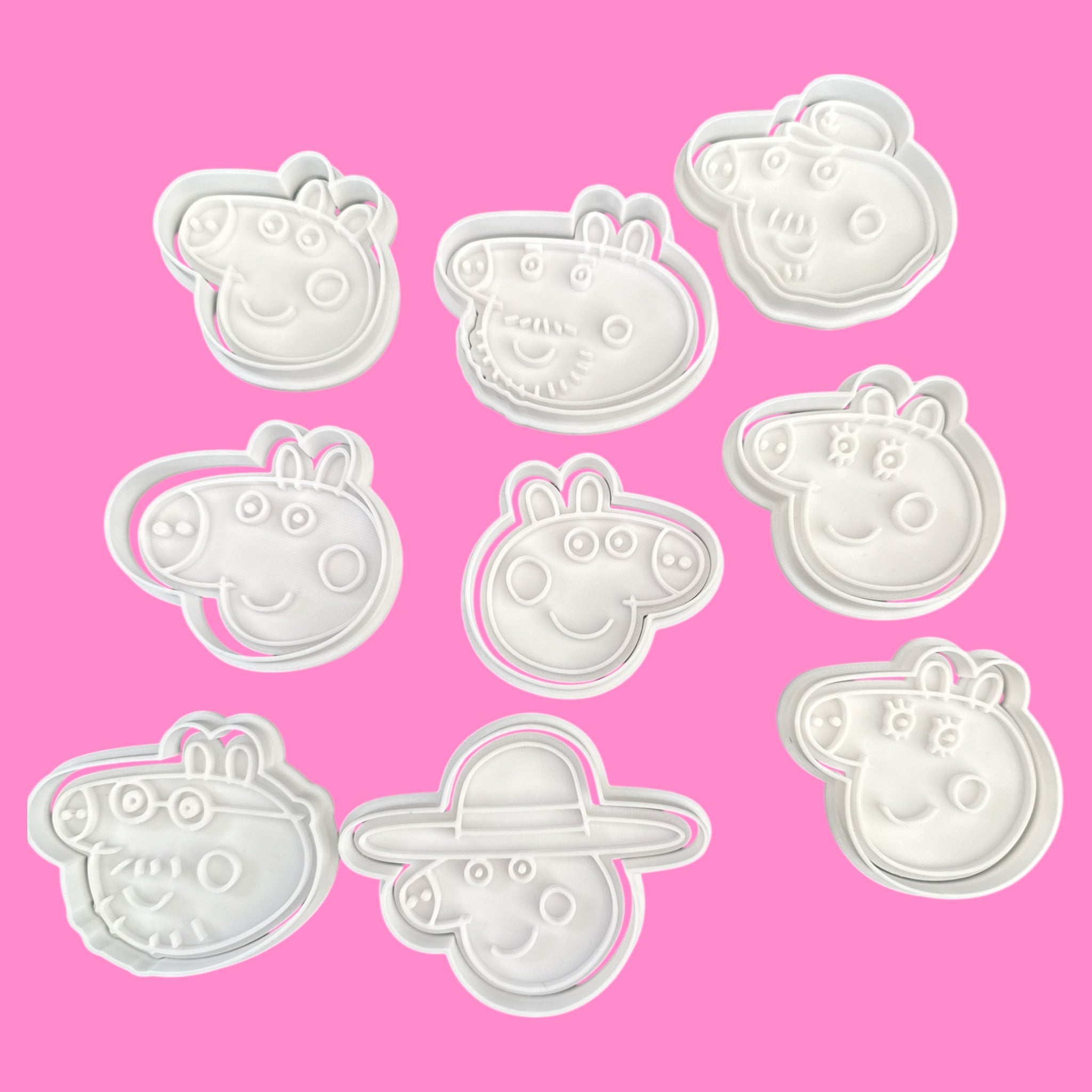 Set of Peppa Pig-themed cookie cutters on a pink background