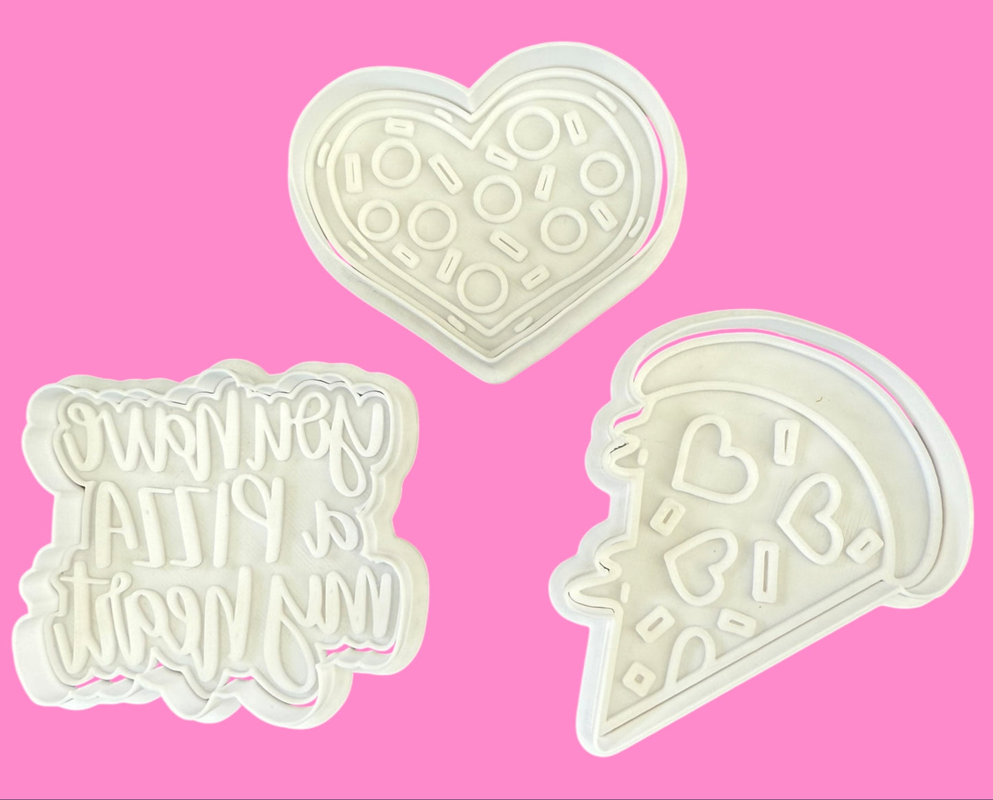 Three white cookie cutters shaped like a heart, square with text, and pizza on a pink background.