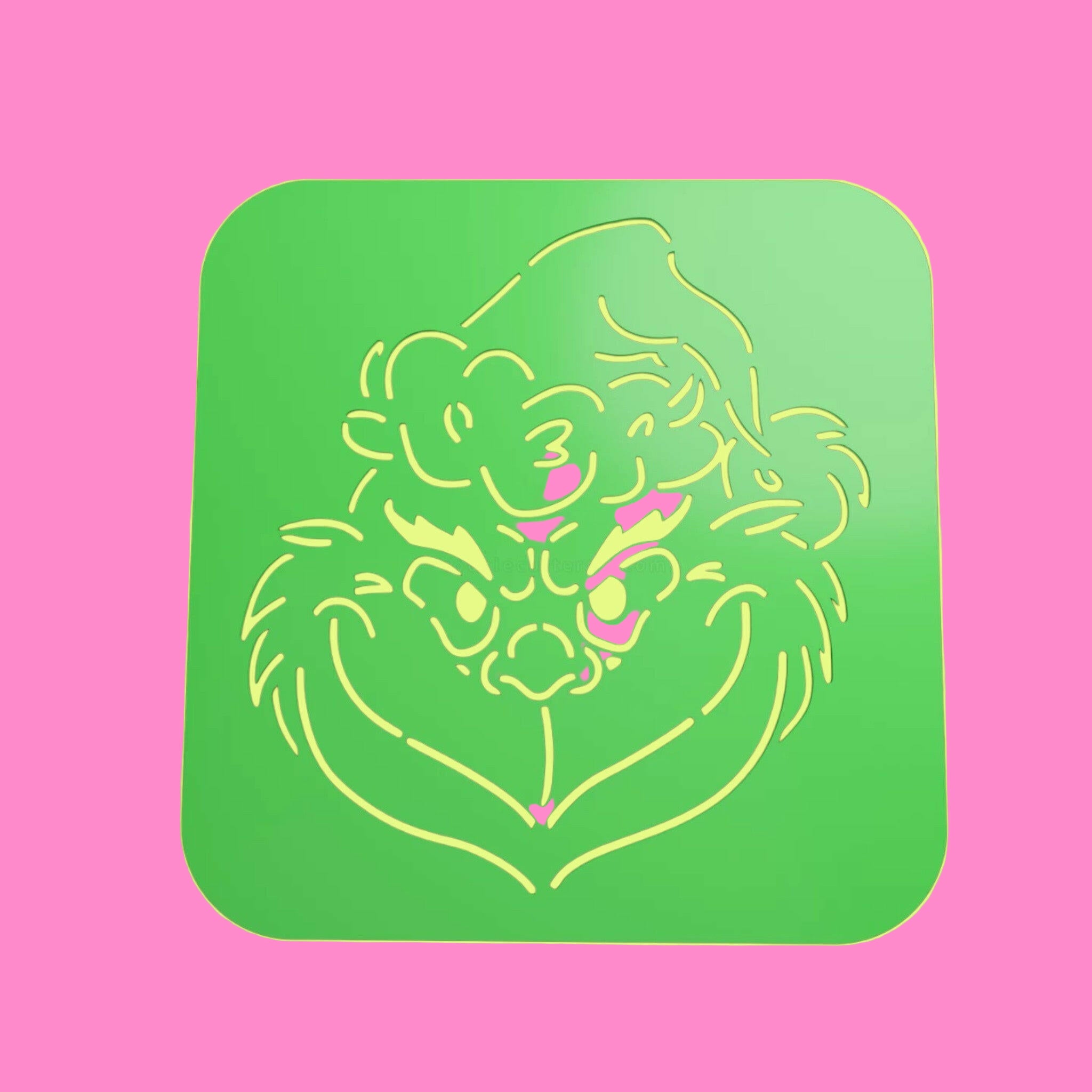 A green square food-safe PLA stencil with a Grinch face design, intended for decorating cookies, cakes, and fondant.