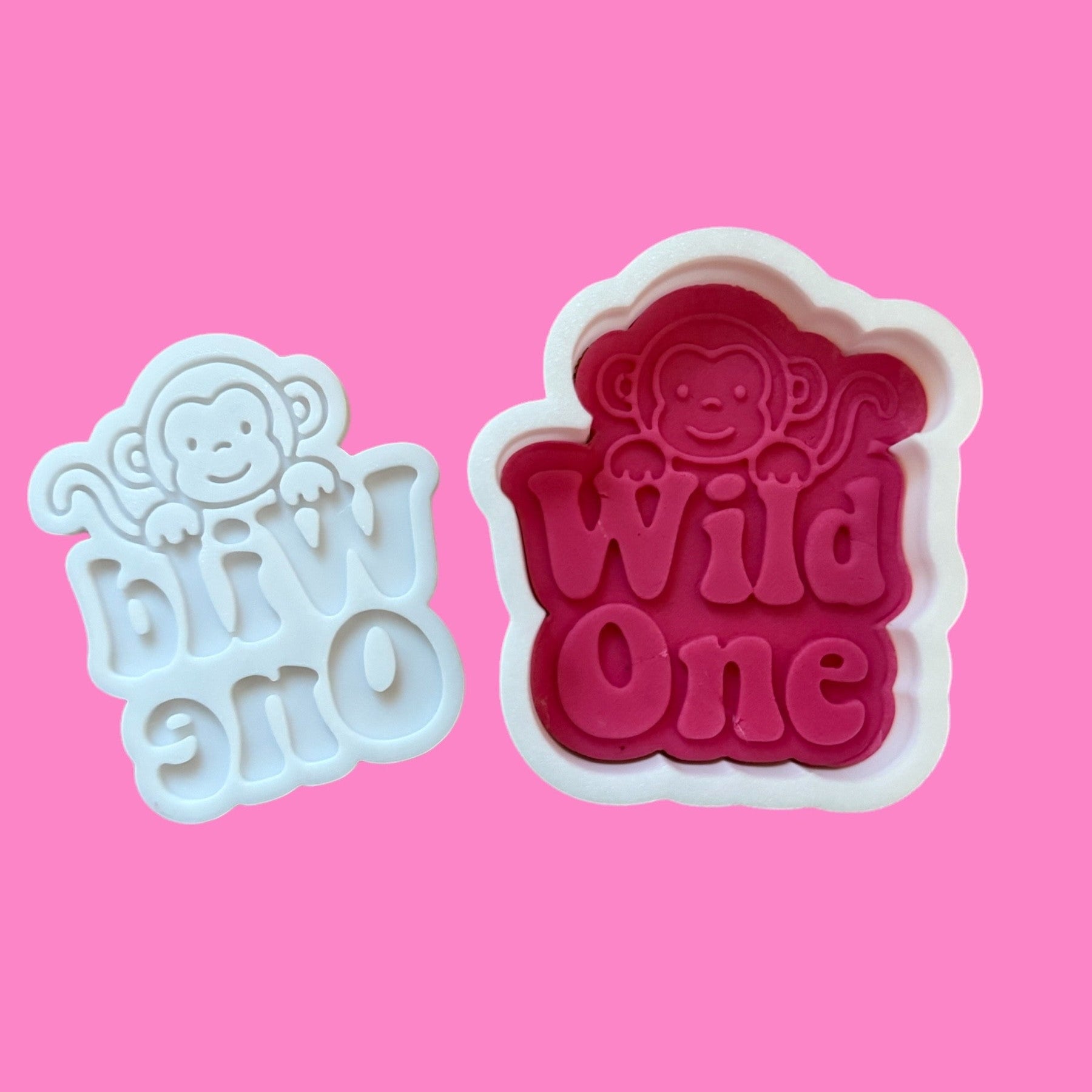 Two-piece cookie cutter and embosser set with a cute monkey design and the phrase 'Wild One' in a jungle-style font.